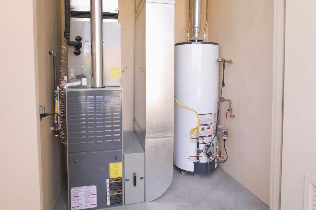 Boiler and water heater in a utility room, showcasing S&P Heating's expertise in boiler installation and maintenance services in Macomb, MI.