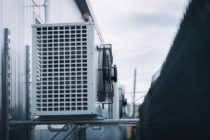 Air conditioning unit installed on a building exterior, showcasing HVAC technology relevant to S&P Heating LLC's services for homeowners.