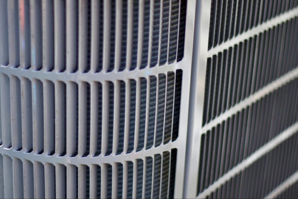 Close-up of an outdoor air conditioning condenser coil, the type of equipment exposed to lake-effect moisture near Lake St. Clair in St. Clair County