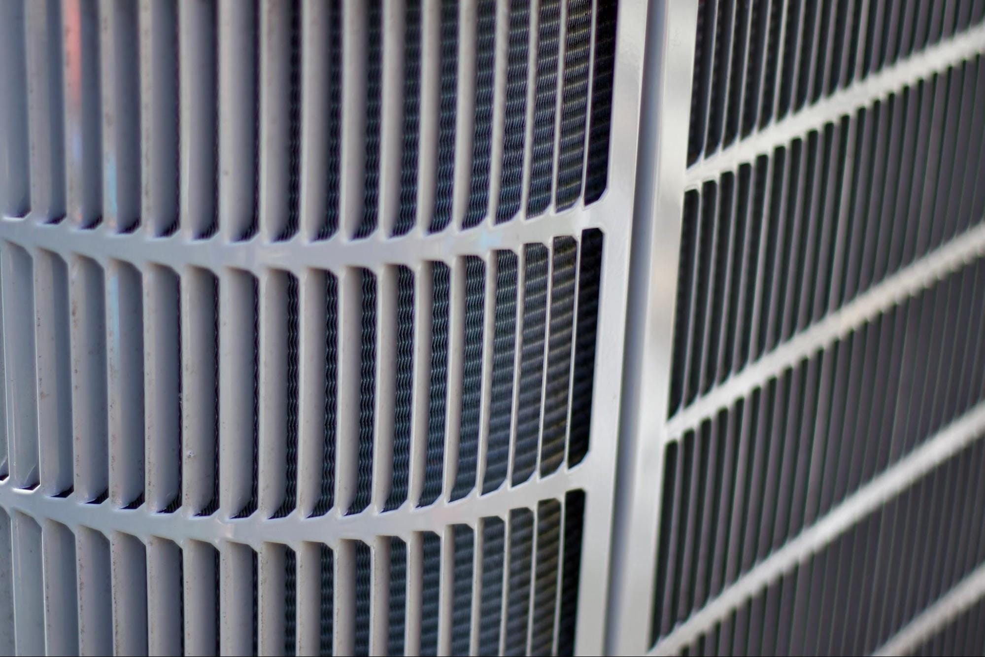Close-up of an outdoor air conditioning condenser coil, the type of equipment exposed to lake-effect moisture near Lake St. Clair in St. Clair County