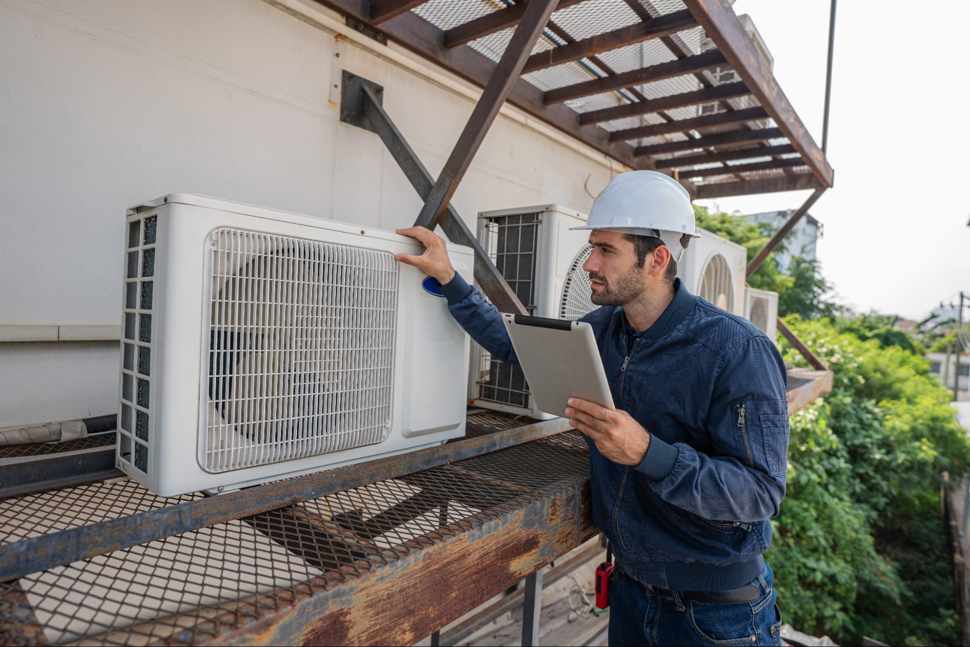 Rooftop air conditioning condenser fans managing cooling performance during Lake St. Clair's humid summer months in St. Clair County